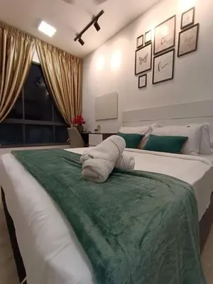 a bedroom with a large white bed with a green blanket at COL 108B Modern KLCC Balcony View & Infinity Pool in Kuala Lumpur