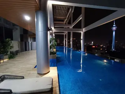 a large swimming pool on the roof of a building with a city skyline at COL 108B Modern KLCC Balcony View & Infinity Pool in Kuala Lumpur