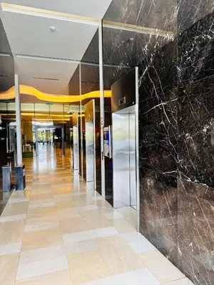 a lobby with black marble walls and a hallway at Mcity Ampang Duplex Groove in Kuala Lumpur