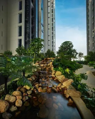 a river in front of two tall buildings at Mcity Ampang Duplex Groove in Kuala Lumpur