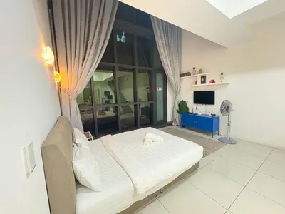 a bedroom with a bed and a large window at Mcity Ampang Duplex Groove in Kuala Lumpur