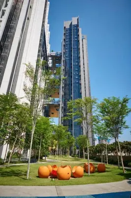a group of orange pumpkins in front of a tall building at Mcity Ampang Duplex Groove in Kuala Lumpur
