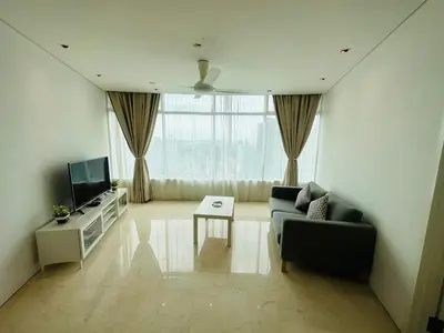 a living room with a couch and a tv at vortex Suites KLCC in Kuala Lumpur
