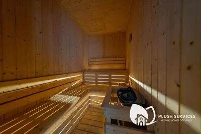 an empty wooden sauna with a bench in it at Alfa Bangsar by Plush in Kuala Lumpur