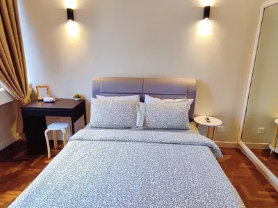 a bedroom with a bed with a desk and two pillows at Newly Reno Wisma Cosway Pavilion KLCC Bukit Bintang in Kuala Lumpur