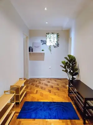 a living room with a blue rug on a wooden floor at Newly Reno Wisma Cosway Pavilion KLCC Bukit Bintang in Kuala Lumpur
