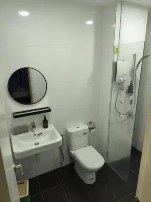a bathroom with a toilet and a sink and a shower at Reizz Residence Majesty Suite in Kuala Lumpur