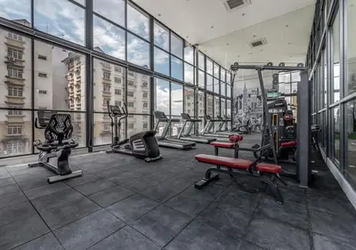 a gym with rows of tread machines in a building at Reizz Residence Majesty Suite in Kuala Lumpur