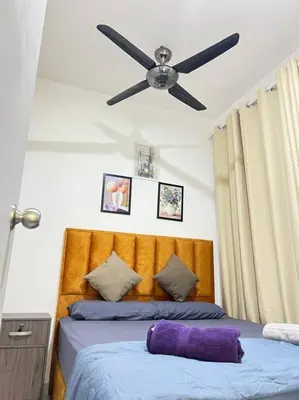 a bedroom with a bed with a ceiling fan at Cozy Kenwingston Platz KL 2-5 Pax2BR&2BR Pakin Netflix 1306 in Kuala Lumpur