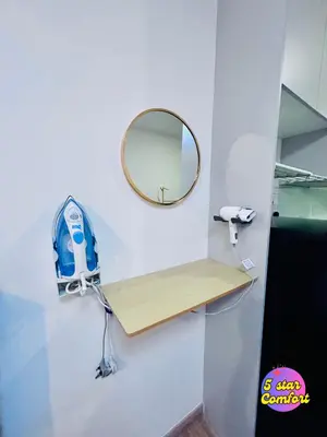 a mirror on a wall next to a wooden shelf at 5 Star Comfort Riveria City KL Sentral Transit Hub 2pax in Kuala Lumpur