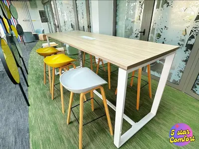 a wooden table with yellow chairs and a table at 5 Star Comfort Riveria City KL Sentral Transit Hub 2pax in Kuala Lumpur