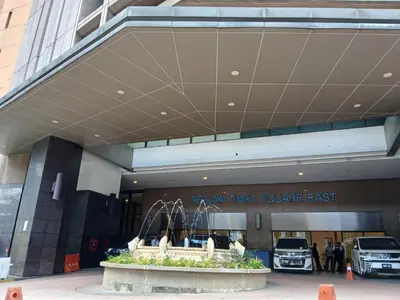 a building with a fountain in front of a car dealership at Family Empire Suites At Times Square in Kuala Lumpur