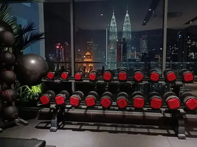 a bunch of wine bottles sitting on a bench in a room at COL 171A Modern Balcony KLCC View & Infinity Pool in Kuala Lumpur