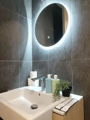 a bathroom with a sink and a mirror at COL 171A Modern Balcony KLCC View & Infinity Pool in Kuala Lumpur