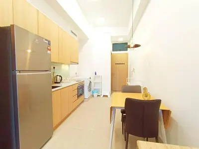 a kitchen with a refrigerator and a table with chairs at COL 23a8A Morden KLCC View Studio in Kuala Lumpur