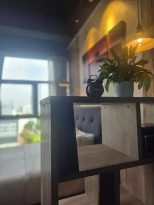 a wooden table with a potted plant on top of it at 3 Towers Jalan Ampang KL in Kuala Lumpur