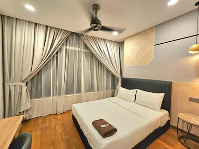 a bedroom with a bed and a large window at The Sky Residence KLCC by AsianHost in Kuala Lumpur