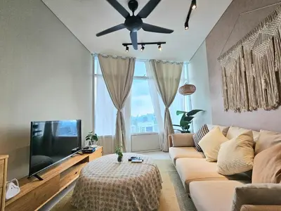 a living room with a couch and a ceiling fan at The Sky Residence KLCC by AsianHost in Kuala Lumpur