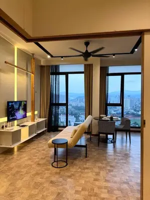 a living room with a ceiling fan and a television at Expressionz Professional Suites Studio in Kuala Lumpur