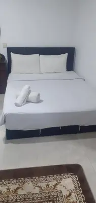 a bed with white socks on it in a room at STAY WITH DAy CAUCON in Kuala Lumpur