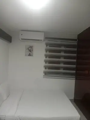 a white room with a bed and a window at STAY WITH DAy CAUCON in Kuala Lumpur