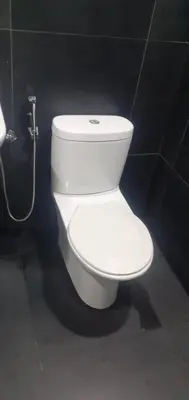 a white toilet in a bathroom with a hose at STAY WITH DAy CAUCON in Kuala Lumpur
