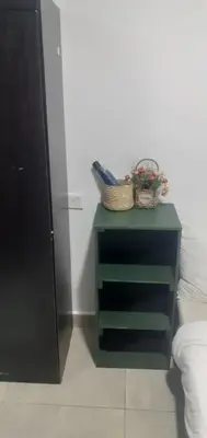a green end table with baskets on it in a room at STAY WITH DAy CAUCON in Kuala Lumpur