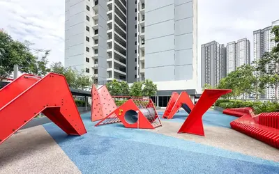 a playground with red play equipment on a blue carpet at Vista Sentul Residences by Airhost in Kuala Lumpur