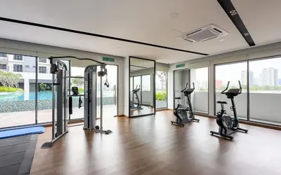 a gym with treadmills and ellipticals in a building at Vista Sentul Residences by Airhost in Kuala Lumpur