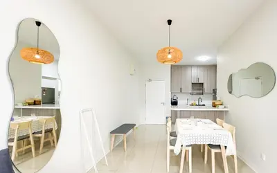 a kitchen and dining room with a table and chairs at Vista Sentul Residences by Airhost in Kuala Lumpur