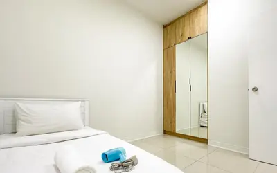 a bedroom with a white bed and a mirror at Vista Sentul Residences by Airhost in Kuala Lumpur