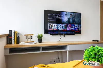 a tv on a shelf in a living room at Skypool with KLCC View - KL Sentral Riveria City Suite Near KL City Centre KLCC in Kuala Lumpur