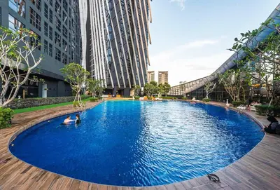 a large blue pool in a city with buildings at Arte Mont Kiara Wonder 2BR Suites in Kuala Lumpur