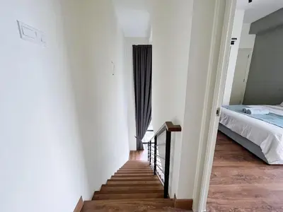 a stairway leading to a bedroom with a bed at Arte Mont Kiara Wonder 2BR Suites in Kuala Lumpur