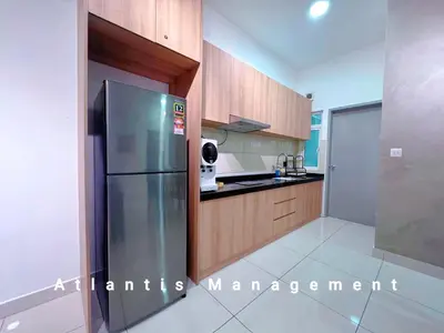 a kitchen with a stainless steel refrigerator and wooden cabinets at TR Residence Block A,Titiwangsa in Kuala Lumpur