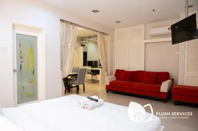 a bedroom with a red couch and a red bed at Parkview KLCC, Bukit Bintang in Kuala Lumpur