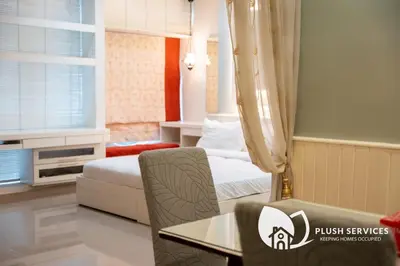 a hotel room with a bed and a table and chair at Parkview KLCC, Bukit Bintang in Kuala Lumpur