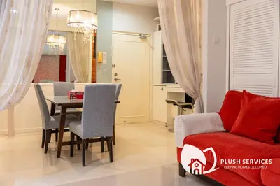 a living room with a table and a couch at Parkview KLCC, Bukit Bintang in Kuala Lumpur