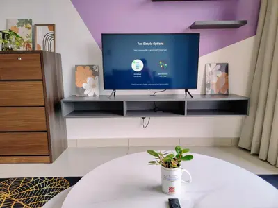 a living room with a tv on a wall at Trion Residence Kuala Lumpur by Luxe in Kuala Lumpur
