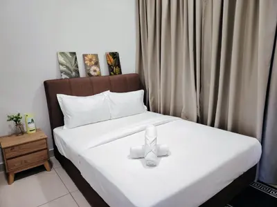 a bedroom with a bed with a bow on it at Trion Residence Kuala Lumpur by Luxe in Kuala Lumpur