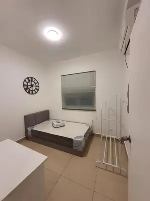 a bedroom with a bed and a clock on the wall at Maxim Citylights Sentul in Kuala Lumpur