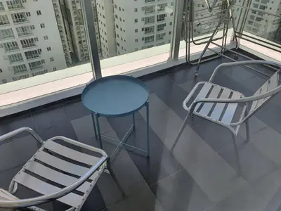 a blue table and two chairs in a window at Maxim Citylights Sentul in Kuala Lumpur