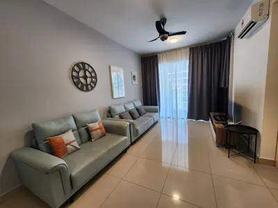 a living room with a couch and a tv at Maxim Citylights Sentul in Kuala Lumpur