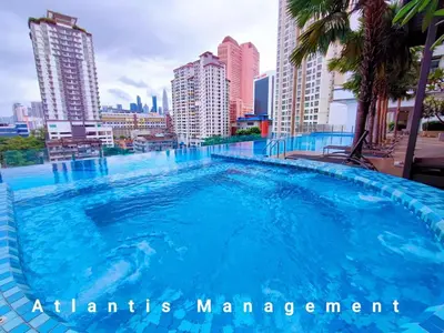 a large swimming pool in the middle of a city at TR Residence Cozy & Luxury Apartment, Walking Distance MRT Titiwangsa & Nearby Titiwangsa Lake Garden in Kuala Lumpur