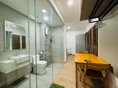 a bathroom with a sink and a toilet and a table at Riveria City By Dream stay in Kuala Lumpur
