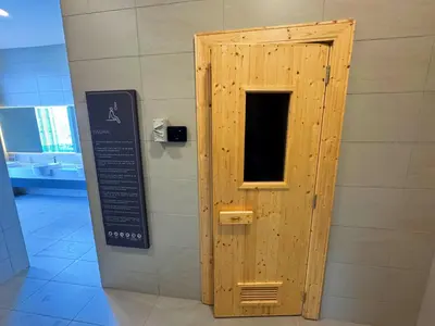 a wooden door in a wall with a sign at The Atrium Ampang KLCC City , 55000Jalan Ampang Hilir, Taman U Thant KLCC in Kuala Lumpur