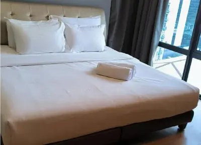 a white bed with a box on top of it at YippieeAnggunHomestay in Kuala Lumpur