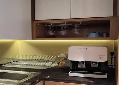 a kitchen counter with a coffee maker on top of it at YippieeAnggunHomestay in Kuala Lumpur