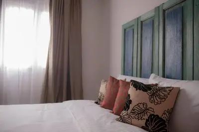 a bedroom with a bed with pillows and a window at Redstone Boutique Hotel Kuala Lumpur in Kuala Lumpur