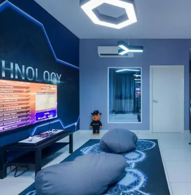 a blue room with a bean bag chair and a monitor at Gaming World Suite In Arte Mont Kiara in Kuala Lumpur